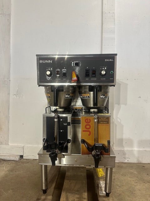 BUNN STAINLESS STEEL HEAVY DUTY COMMERCIAL COUNTER TOP DUAL COFFEE GRINDER/BREWER WITH WARMERS AND HOT WATER SPIGOT ON LEGS - Second Life - Equipment - collection_name