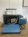 COMMERCIAL HEADYDUTY AUTO FEED HIGH SPEED POLY STRAPPING MACHINE - Second Life - Equipment - collection_name